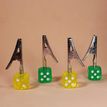 Load image into Gallery viewer, Roach Clips with yellow and green dice attached at the ends, serving a worry-free session

